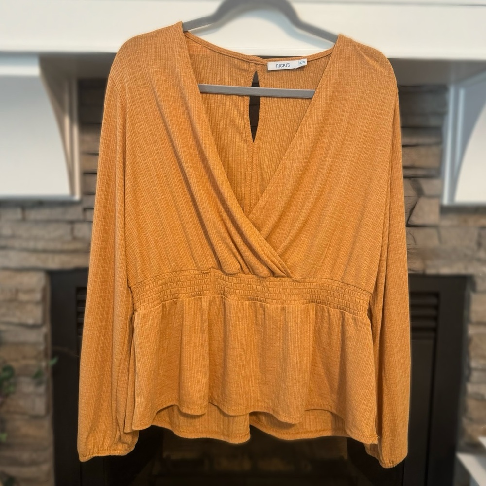 Ricki’s orange blouse in great condition.